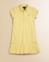 Flirty box pleats detail the hem of this chic drop-waist silhouette with button tab detail. Polo collar Short sleeves Banded cuffs Button down placket Embroidered logo pony at chest Button-through tabs at sides Box pleated hem Drop-waist 98% cotton/2% elastane Machine wash Imported 