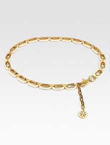 Glossy resin links accented with radiant goldtone details and an iconic logo charm. Width, about 1Imported 