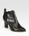 Comfortable leather silhouette with a stacked heel and timeless point toe. Painted stacked heel, 3¼ (80mm)Leather upper with side elastic goresBack pull-tabLeather lining and solePadded insoleMade in ItalyOUR FIT MODEL RECOMMENDS ordering one half size up as this style runs small. 