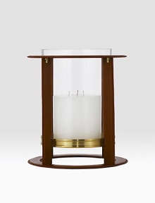 Crafted from gleaming glass, and encased in a supple saddle leather frame to evoke a heritage panache.12 L x 14¼ H6 X 6 candle recommendedLeather, glass and brassImported