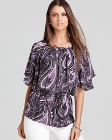 With a nod to the '70s, this MICHAEL Michael Kors top embraces paisley print with a blouson bodice and flutter sleeves. Modernize the retro silhouette with sleek skinny jeans for the ultimate fashion mix.