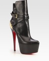 An exaggerated platform lifts this on-trend leather ankle boot, backed by a gleaming goldtone metal detail. Self-covered heel, 6¼ (160mm)Hidden platform, 2½ (65mm)Compares to a 3¾ heel (95mm)Leather and metal upperAdjustable buckle strapLeather liningSignature red leather solePadded insoleMade in Italy