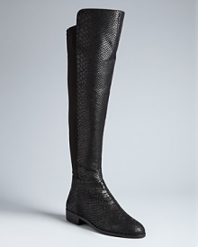 Python-embossed leather lends sensual appeal to these long, tall MICHAEL Michael Kors boots. Stretch backs make them sleekly, perfectly fitting: Snake it up.