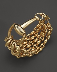 Bold, gleaming horsebits anchor shining chains of 18K yellow gold. By Gucci.