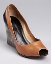 A distressed wooden wedge adds unique appeal to a pair of bi-color wedges from CoSTUME NATIONAL--a black patent panel details the back of this sleek peep toe silhouette.