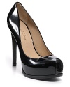 Patent leather pumps with a hidden platform and a low-cut vamp create a sultry silhouette.