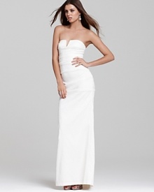 Though understated, this Nicole Miller strapless gown undoubtedly makes a statement. Subtle ruching down the length of the silhouette creates a figure-flattering shape.