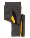 Splashes of yellow and sporty stripes update these classic track pants by PUMA.