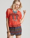 This Free People top is the latest to crop up, complete in sheer crochet for trend-right style with a playful sensibility. Pair it with printed shorts for an of-the-moment pairing of patterns and textures.