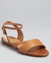 In classic, natural-hued leather, the Bethany flat sandals exude effortless, comfortable style. From Salvatore Ferragamo.