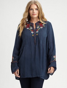 Featuring classic pleats and lively embroidery, a must-wear tunic. Try wearing this top with slim-fitting pants or leggings.Round neckLong sleevesButton placketEmbroidered detailsAbout 32 from shoulder to hemRayonMachine washImported