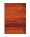 Abstract and dramatic, this handcrafted wool rug features a rich spectrum of shades from burnt orange tones to deep reds. The ethereal coloration pattern is reminiscent of a vivid sky at sunset. Luster-wash finish creates gently-diffused color variation.