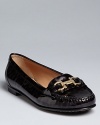 Salvatore Ferragamo makes these loafers shine in gleaming patent and gold-tone hardware.