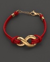 An elegant chain bracelet with an edgy appeal combing 18 Kt. gold and rich red leather.