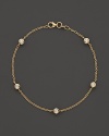 Diamond stations on a fine yellow gold chain bracelet.