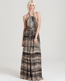 A decadent Rachel Zoe halter neck gown creates a sensation on the red carpet with its burnout silk pattern and tiered ruffle skirt. Embellished with metallics, the silhouette redefines gorgeous for a season of opulent glamour.