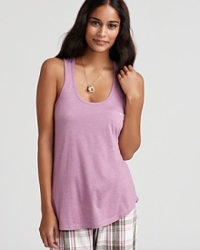 A soft racerback tank top with a button welt pockets at left chest.