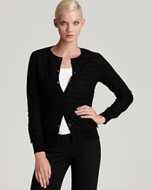 A knit Trina Turk cardigan features a sheer lace overlay, lending a ladylike finish to any daytime ensemble.