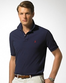 Short-sleeved polo shirt cut for a comfortable, classic fit. Breathable, durable cotton mesh. Two-button placket. Ribbed polo collar and armbands, uneven vented hem. Embroidered pony accents the chest.