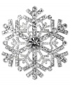 Perfectly unique: a wintry snowflake pin from Jones New York. The detailed silhouette sparkles with crystal accents. Crafted in silver tone mixed metal. Approximate diameter: 2 inches. Includes gift box.