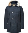 Stylish and sporty navy down coat in a washable cotton blend from the American heritage label Woolrich - Tapers slightly at waist, hits at mid-thigh - Rabbit fur collar lends this coat a veritable feeling of warmth and luxe - Water and snow resistant, with multiple pockets and hood - Exceptionally warm, can be worn in temperatures as low as -30 F - A versatile, classic coat perfect for both city streets and country slopes