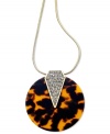 Exotic and dazzling. This pendant necklace from GUESS features chic tortoise in a circular design with glistening crystal accents. Crafted in gold tone mixed metal. Approximate length: 32 inches + 2-inch extender. Approximate drop: 2-1/2 inches.