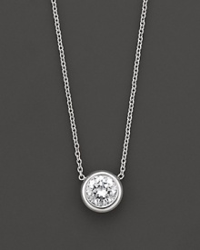 White gold bezel-set diamond solitaire necklace. With signature ruby accent. Designed by Roberto Coin.