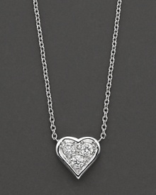 A delicate pendant diamond-encrusted heart necklace in 18 Kt. white gold, with signature ruby accent. Designed by Roberto Coin.