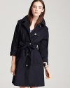 This chic navy MARC BY MARC JACOBS trench coat boasts a button-embellished tie belt and epaulets for a season of fashion-forward looks.