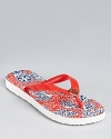 A bright, patterned footbed lends graphic punch to a summery pair of Tory Burch flip flops.