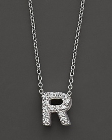 From the Tiny Treasures collection, a diamond R necklace. With signature ruby accent. Designed by Roberto Coin.