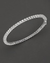 An classic diamond tennis bracelet in white gold adds an elegant touch to any look.