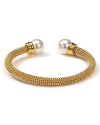 Majorica's gold bangle exudes cool confidence. Solo or stacked, wear yours at cocktail hour to give night time looks a strong spin.