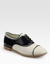 A classic oxford with a unique patent leather and canvas contrasting style. Patent leather and canvas upperLeather lining and solePadded insoleMade in ItalyOUR FIT MODEL RECOMMENDS ordering one half size up as this style runs small. 