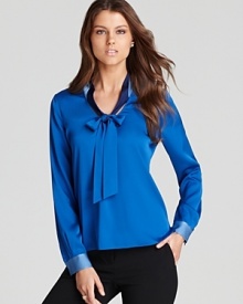 Approach color blocking with sophisticated restraint in this Elie Tahari blouse, flaunting a fluid silhouette and generous neck tie for luxe appeal.