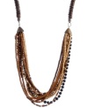 Create a subtle layered effect with earth tones. Brown, black and white glass and wooden beading make Haskell's trendy long necklace a neutral go-to that blends with any look. Set in brass-plated mixed metal. Approximate length: 33 inches.