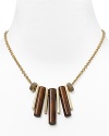 Give your look an on-trend hit of texture with this statement necklace from MARC BY MARC JACOBS. With wooden pipe charms, it's a natural way to enliven your neckline.