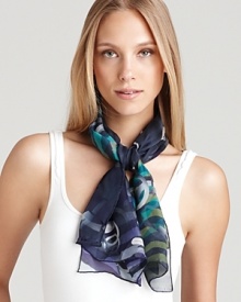 A long silk scarf with a whimsical print of floating gancinis and ombré animal print.