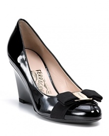 Wedges are a must-have this season and Savatore Ferragamo puts out a pretty pair. Patent leather wedges with signature bow and nameplate at toe.