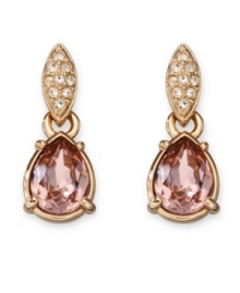 Warm and rosy, these crystal drops by Swarovksi evoke vintage romance. Earrings set in gold-plated mixed metal feature teardrop-shaped rose crystals suspended from ovals of clear crystal pave. Approximate drop: 1 inch.