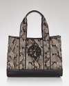 Tory Burch gives her classic logo-embossed tote an exotic update that's designed to look chic on and off the beach.