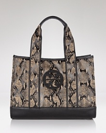 Tory Burch gives her classic logo-embossed tote an exotic update that's designed to look chic on and off the beach.