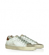 Modeled after vintage tennis shoes, this high-end version from Golden Goose will add an instant upgrade to your casual-cool style - Round suede toe, lace-up front, leather upper with perforated side star detail, contrasting embossed leather logo detail, stylishly distressed rubber sole - Style with skinny jeans, a mini-skirt, or cut off denim shorts