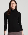 With a long, tunic length, Eileen Fisher's slimming scrunch-neck top is perfectly paired with the skinniest jeans.