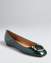 In high-polish leather with distinctive logo accents, these flats are fabulously Salvatore Ferragamo.