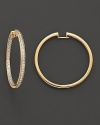 Inside out pavé-set diamond hoop earrings in yellow gold.