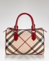 Burberry's iconic check lends luxe style to this classic bowling bag silhouette.