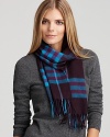 Vibrant cyan stands out against rich aubergine on this luxe cashmere scarf from Burberry.