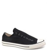 Slip-on Chucks with tongue sewn-in. Laceless-style with minimal construction. Eyelet detail across foot. Contrasting rubber sole.