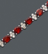 A tennis bracelet to die for. Bold oval-cut garnet (17 ct. t.w.) and diamond-accented links add instant drama. Bracelet crafted in sterling silver. Approximate length: 7 inches.